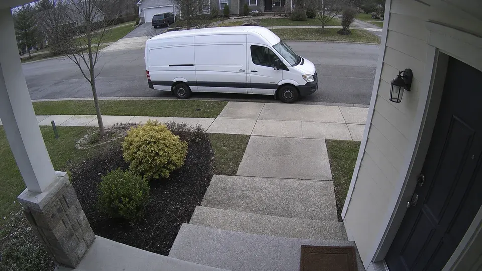 delivery van parked in front of the house